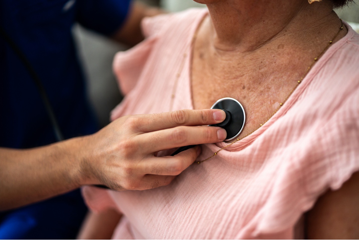 Doctor checking patient's heart