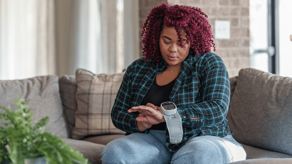 A woman monitoring her blood sugar levels to help in reversing prediabetes