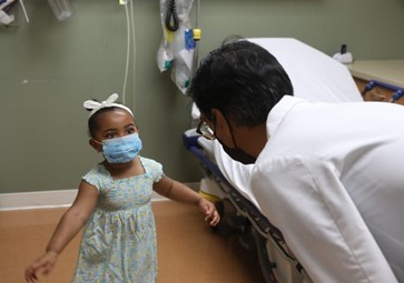 Doctor checking in with a girl who received monkeypox vaccine in New Jersey