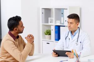 A patient and doctor sitting at a table discussing testicular cancer