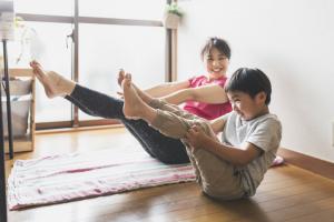 Mother and child practicing yoga to help get rid of pandemic weight