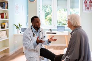 Doctor explaining various bladder issues to an elderly patient