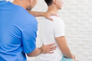 Neurologist examining a patient's spine disorder