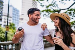 Two people laughing on a date in the park