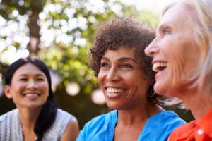 Closeup of three women laughing outside