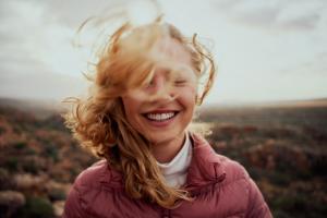 Smiling woman looking at the camera in the wilderness