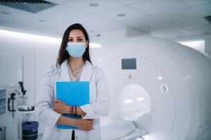 Masked woman undergoing an MRI scan