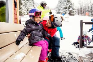 Mother smiling at her daughter on a family ski trip