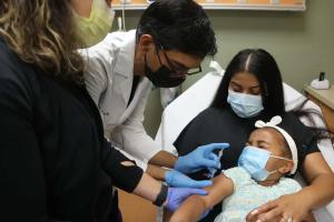 New Jersey doctor administering monkeypox vaccine to a young girl