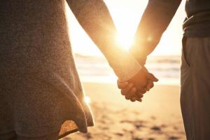 Couple holding hands on beach