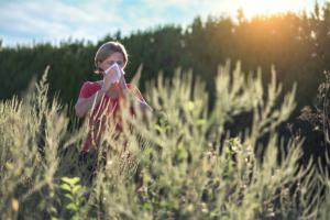 woman in a field experiencing fall allergies