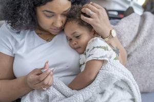 Mother holding her sick toddler