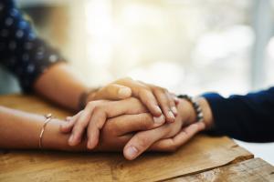 Summit, New Jersey nurse navigator holding the hands of a cancer patient