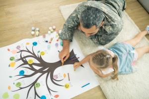 Father and daughter looking at family tree