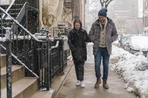 Man and woman walking practicing winter safety tips