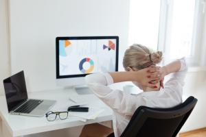 Woman stretching at computer desk