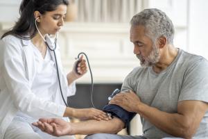 Doctor checking patient's blood pressure