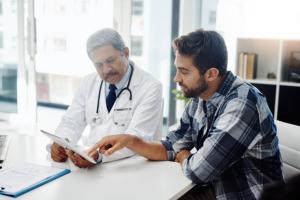 Man reviewing test results with doctor