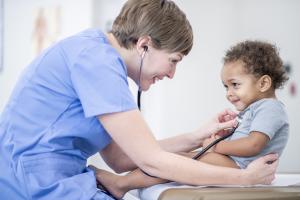 Doctor checking an infant's heart rate