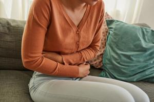 Woman holding her stomach with stomach pain