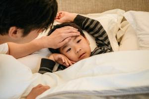 Child with hand, foot, and mouth disease with doctor