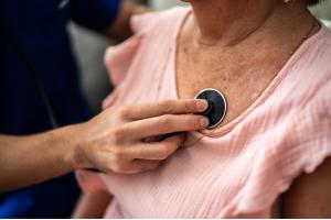 Doctor checking patient's heart