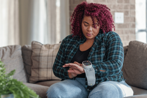 A woman monitoring her blood sugar levels to help in reversing prediabetes