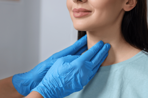 Summit Health endocrinologist examining a woman’s neck for early signs of thyroid problems