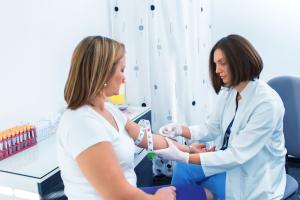 Summit Health doctor drawing blood to test a woman’s hemoglobin levels.